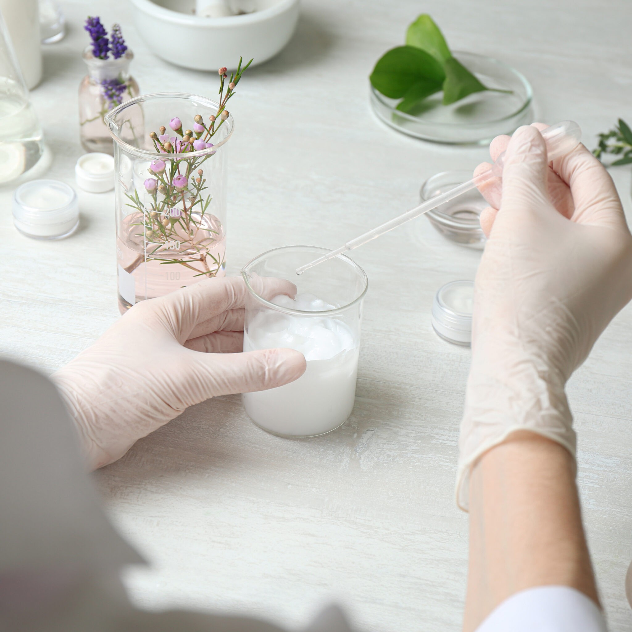 Scientist developing cosmetic product in laboratory, closeup