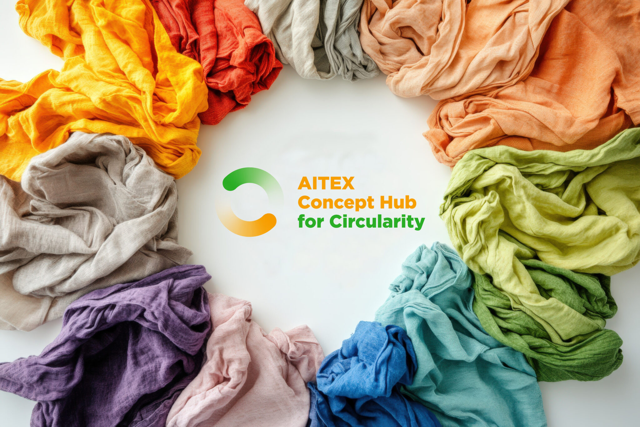 Crumpled colorful textile waste forming a circle around a recycling sign on a white background promoting sustainable fashion